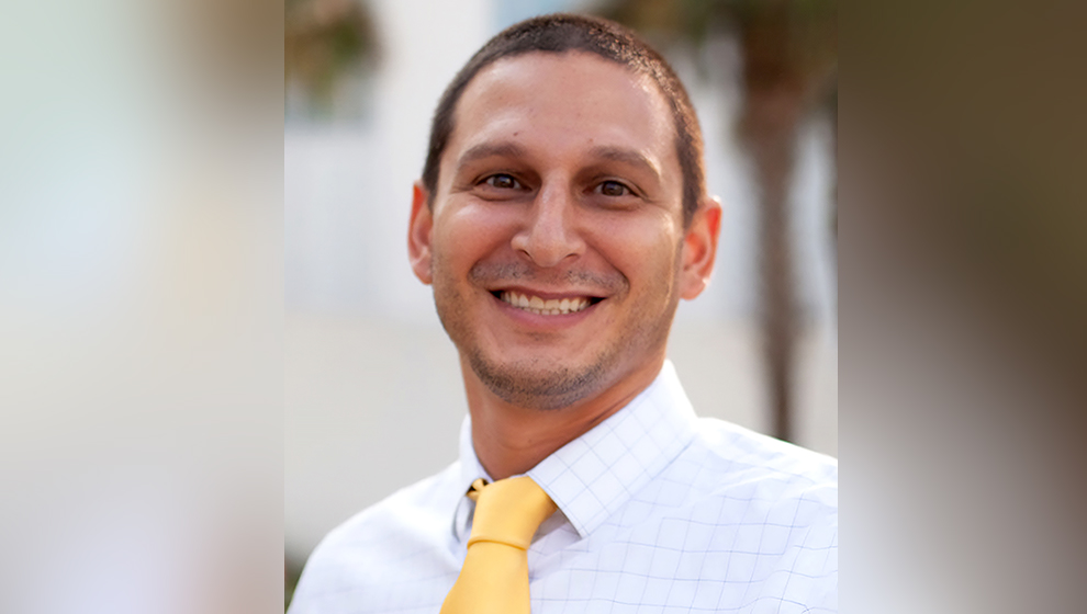 Smiling bankruptcy lawyer in formal shirt and tie.