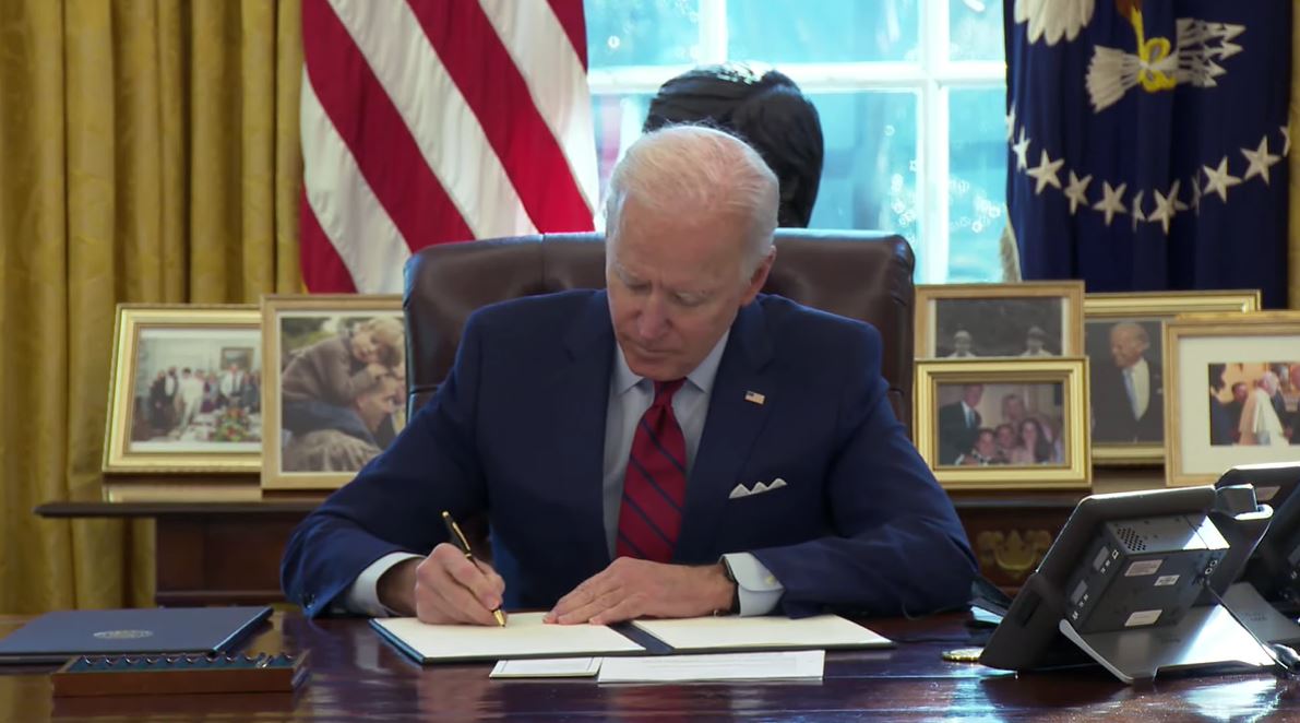 Joe Biden signing an executive order