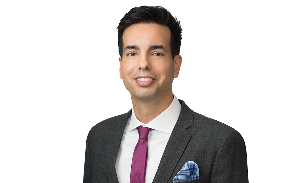 California employment law expert in suit standing in front of white background.