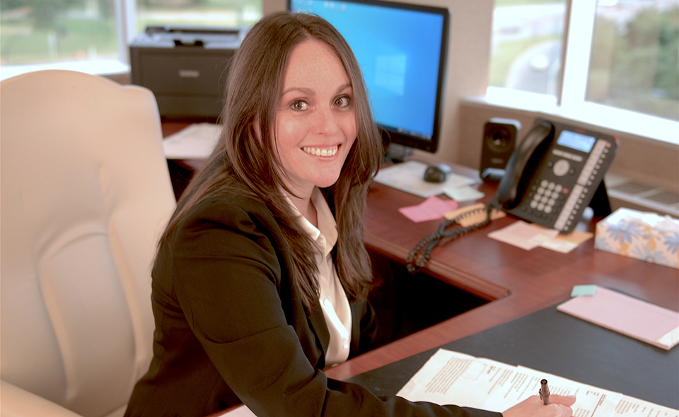 Female family lawyer sitting at an office desk.