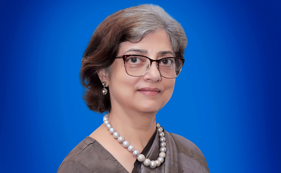 Prominent patent attorney Anju Khanna stands in front of a blue background.