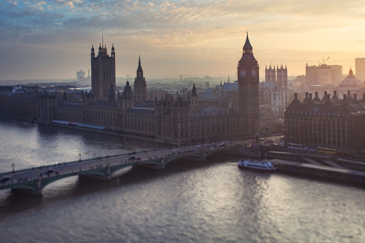 Houses of parliament and Thames river at sunset.