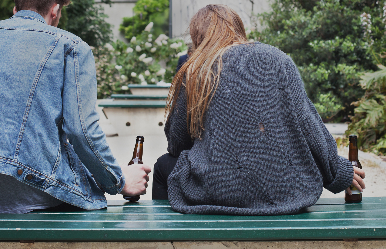 alcoholism concept, young people drinking beer on the street