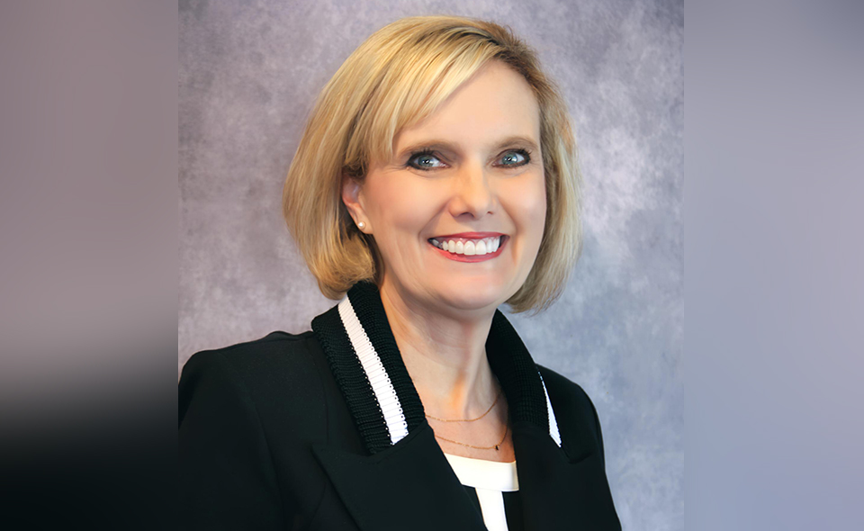 Experienced lawyer Tangi Carter standing in an office.