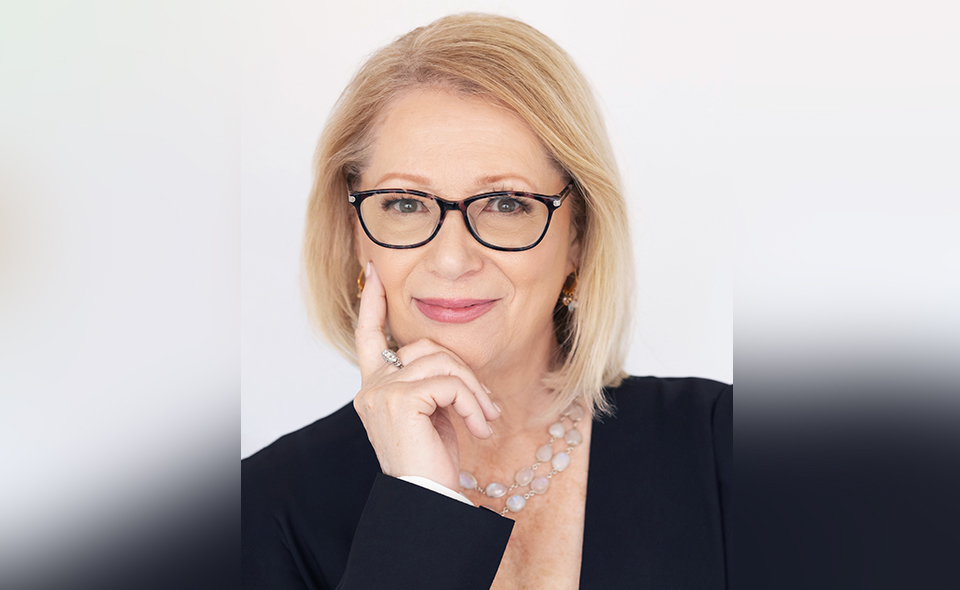 Employment lawyer Marian Birge standing before a white background.