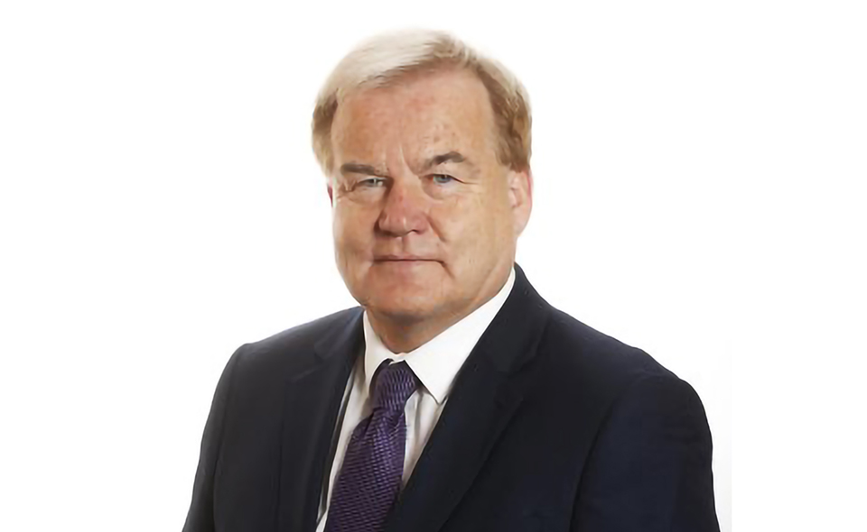 Barrister Christopher Lehane standing in front of a white background.