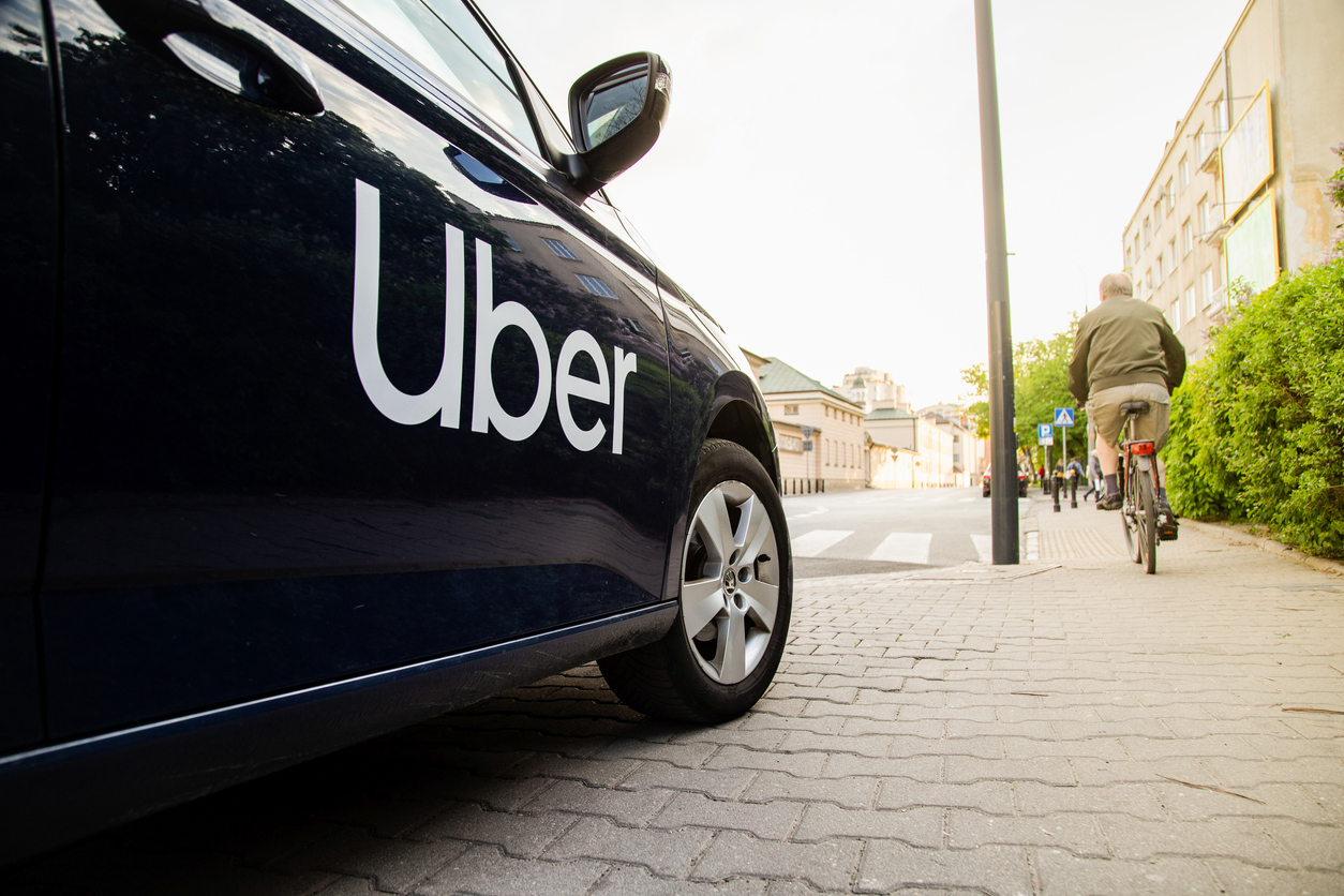 Uber taxi parked at the side of the road.