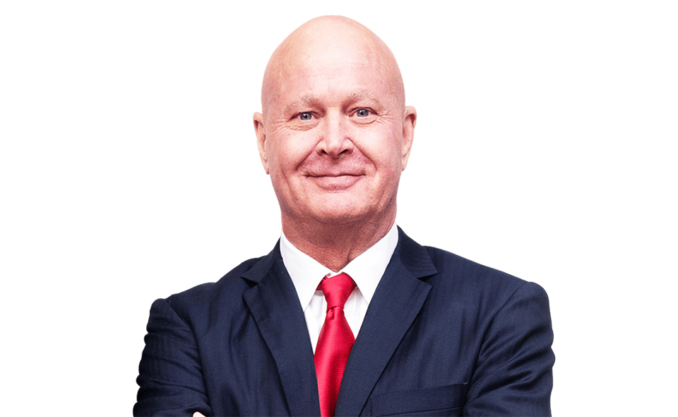 Personal injury specialist Greg Baumgartner standing in front of a white background.