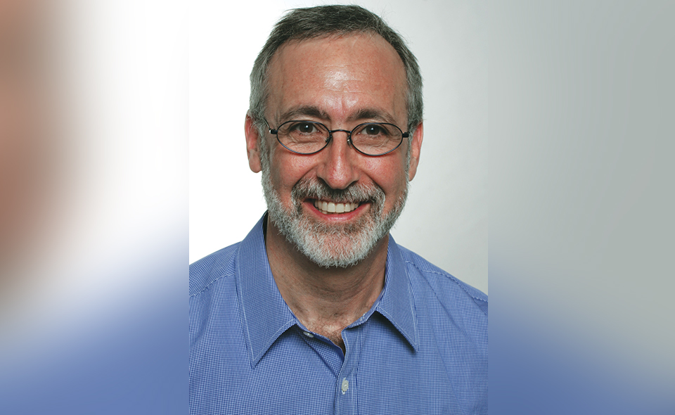 Zoning law specialist Howard Goldman standing before a plain wall.