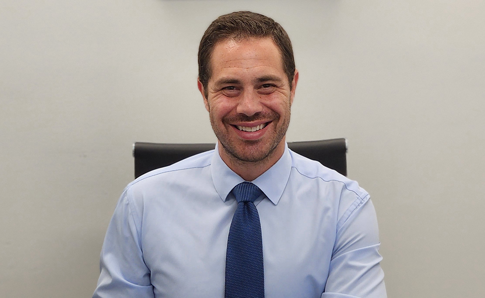 Auto accident specialist Steven Jacobson sitting in his office.