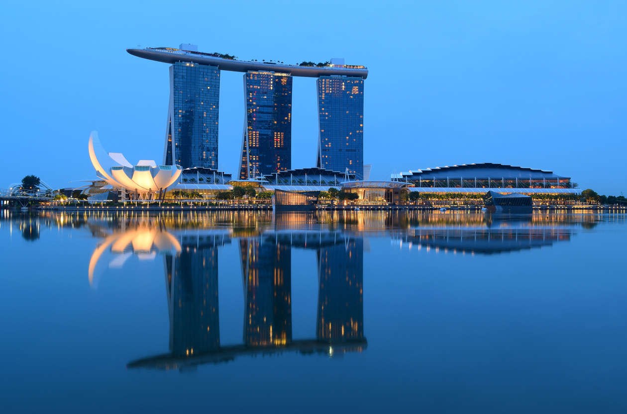 Singapore City, Singapore - May 22, 2016: Marina Bay Sands Hotel and Art Science Museum reflection on the river during the blue hour in Singapore.