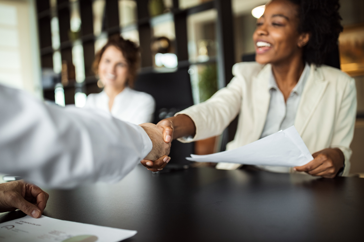 Business woman making plans with somebody, shaking hands.