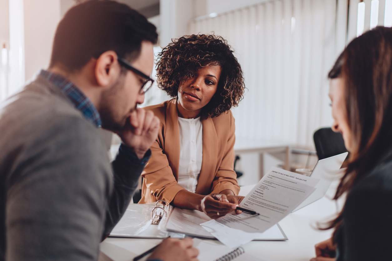 Couple preparing to sign a contract of sale and having second thoughts