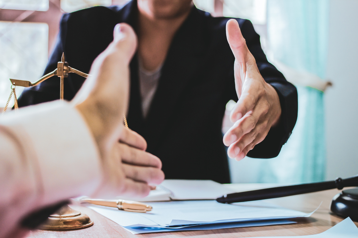 close up shake hands lawyers in office. counseling and give an advice between private and government officials to find a fair settlement.