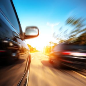 A car driving on a motorway at high speeds, overtaking other cars