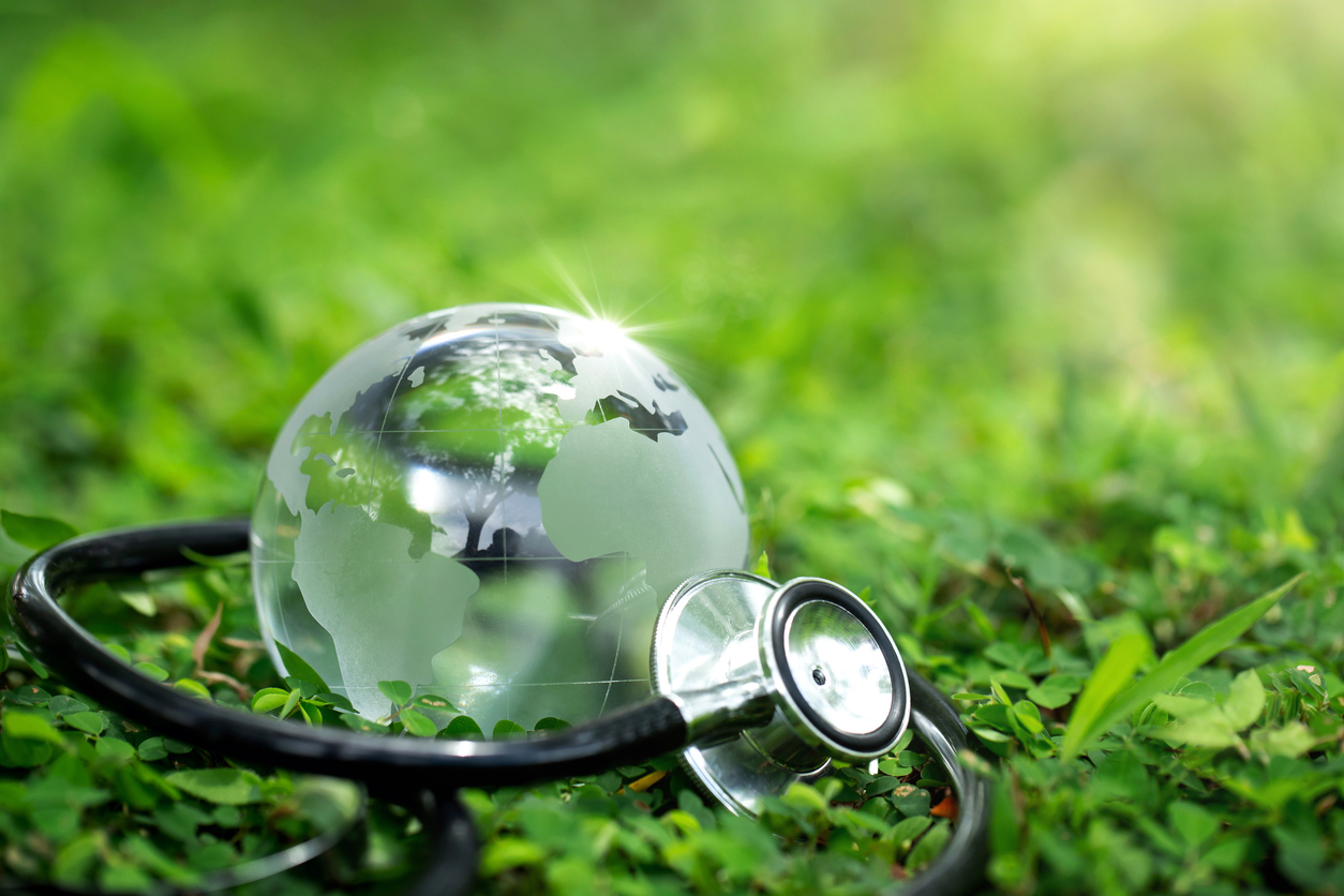 environment earth day concept.crystal earth with a medical doctor's stethoscope on green.saving environment, and environmentally sustainable. save earth. global healthcare and green earth day. esg