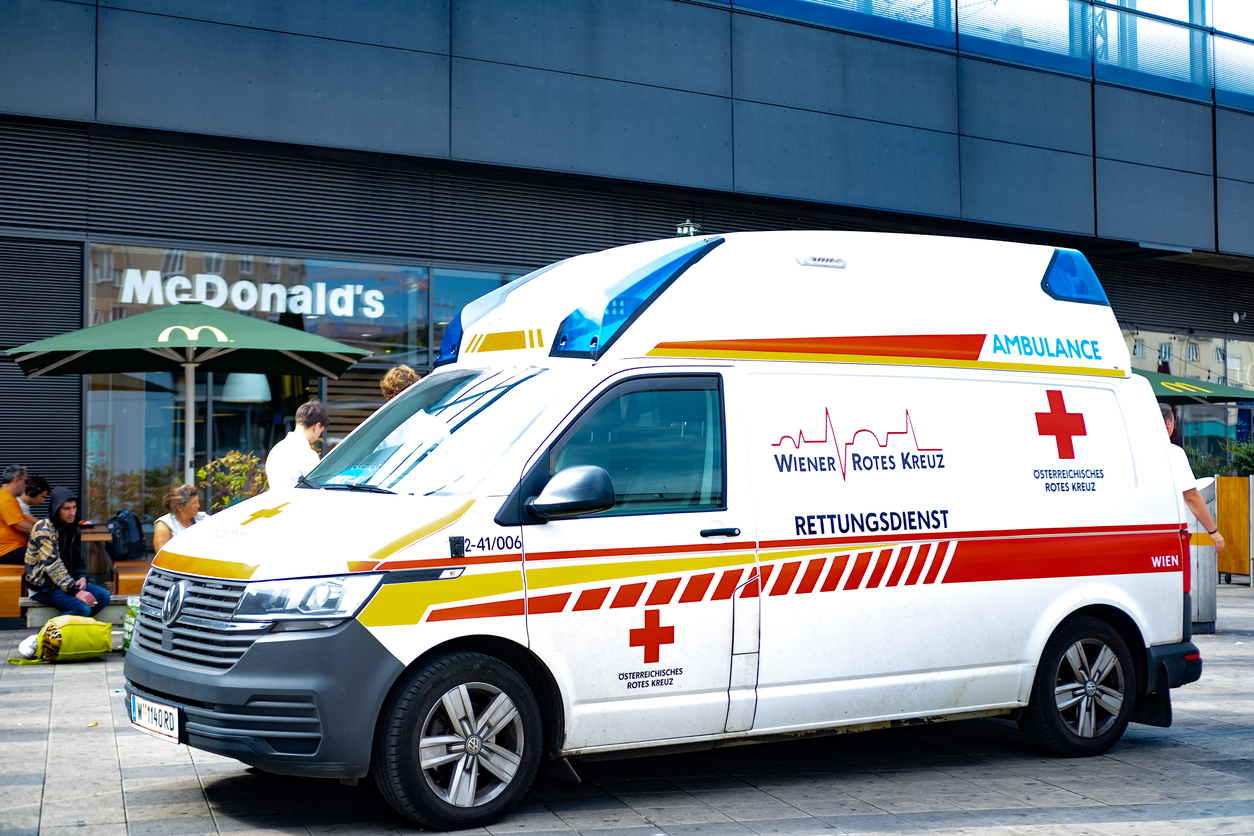 austrian ambulance stationed in front vienna central train station, emergency response in busy city setting, efficient medical response, vienna, austria august 1, 2024