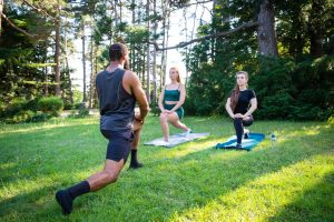 Three employees exercising to improve their mental health and wellbeing