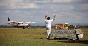 kenya bateleur camp arrival staff waving at guests