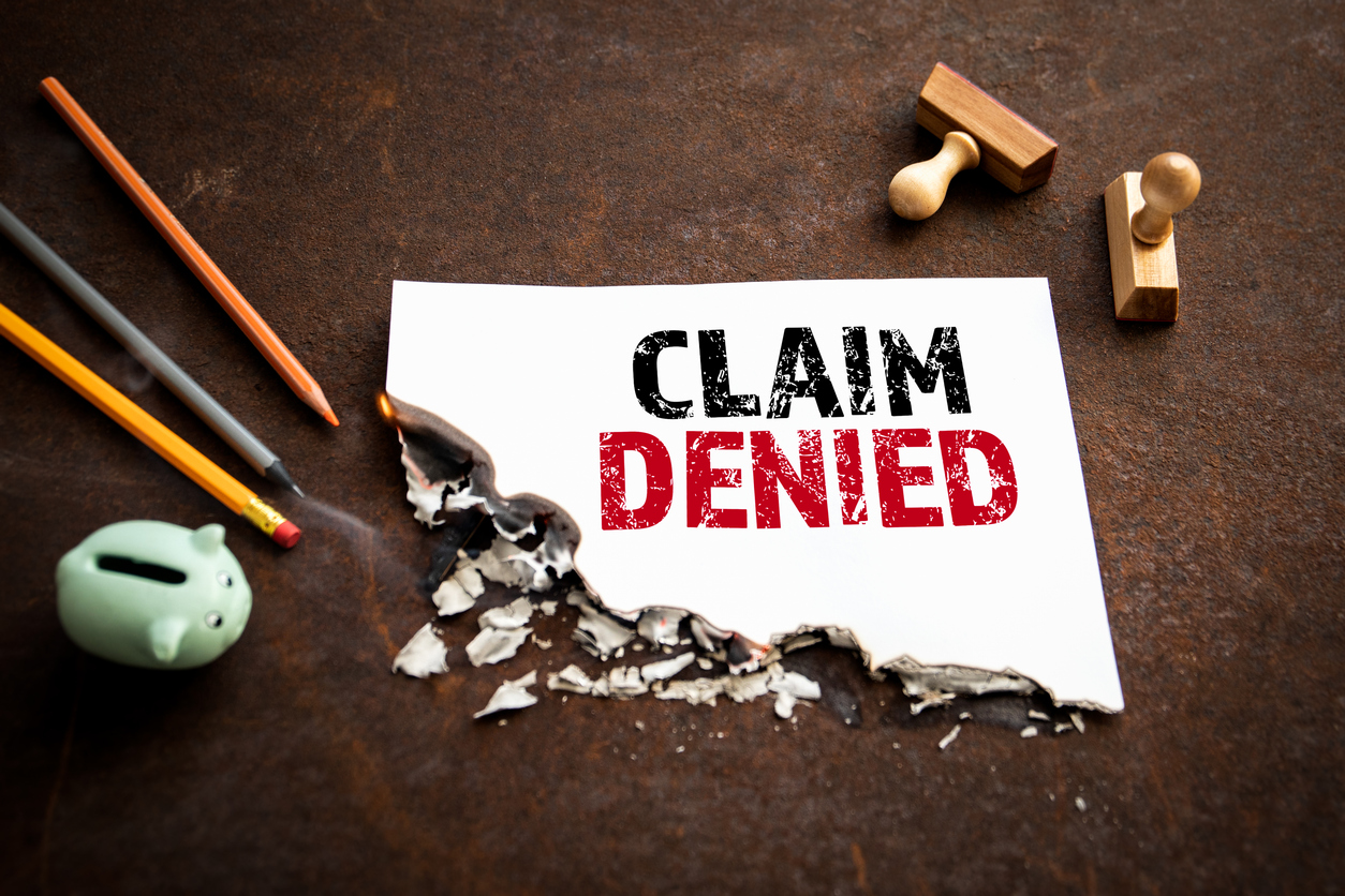 claim denied. text on a burning piece of paper