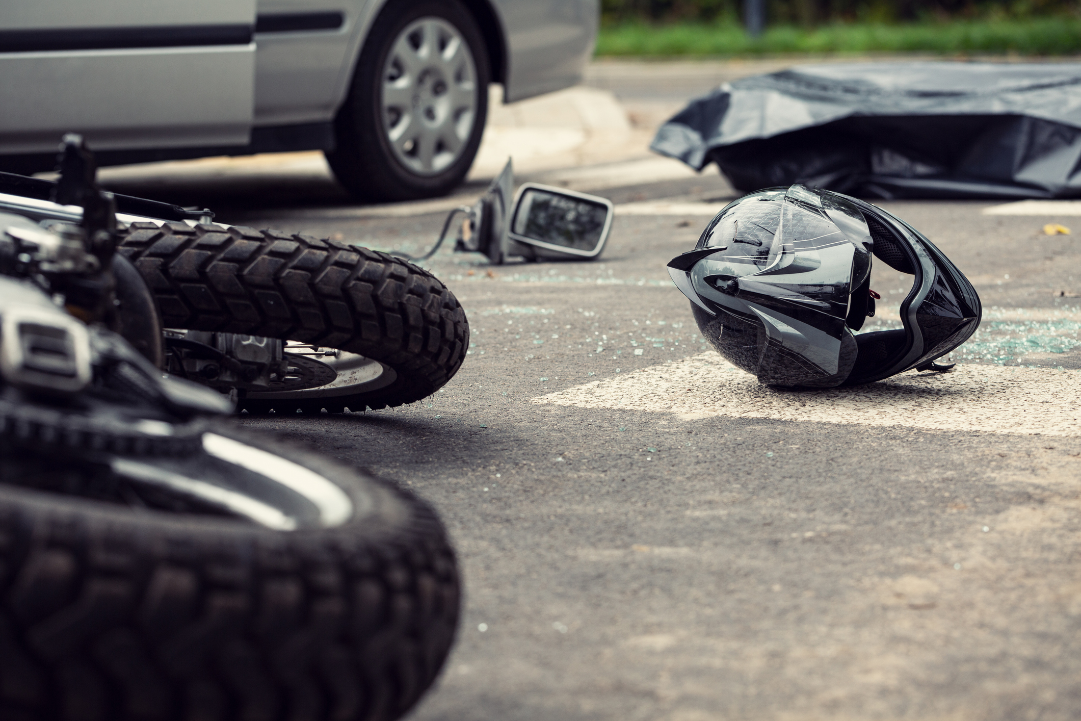 motorcycle and helmet on the street after dangerous traffic incident