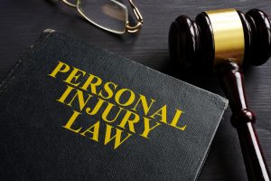 personal injury law book and a black desk.