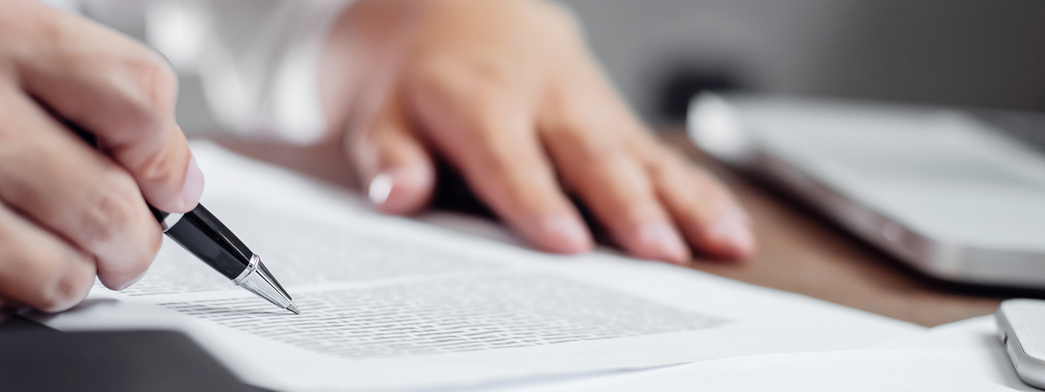 insurance agent checking policy documents in office.