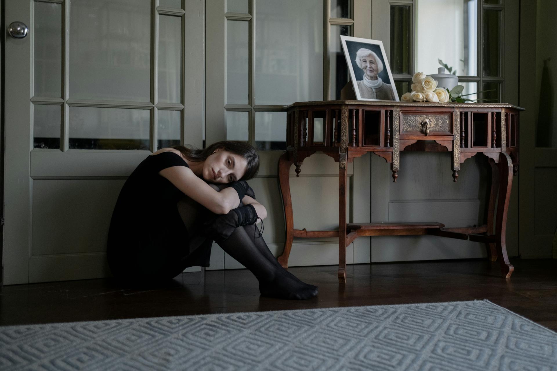 An Emotional Woman Sitting on the Floor