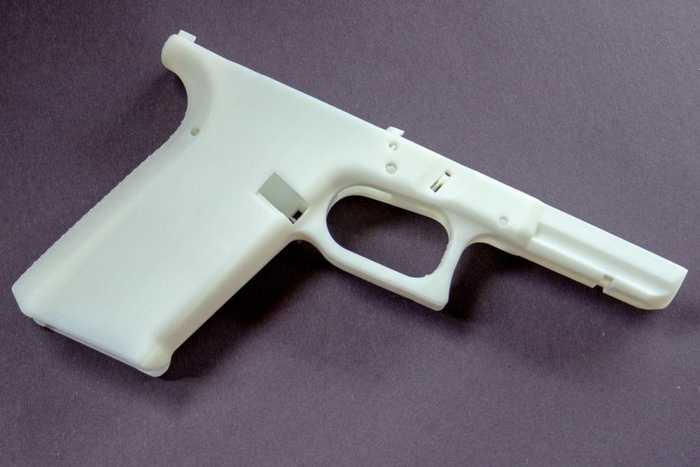 a,closeup,of,3d,printed,white,"ghost,gun",on,a