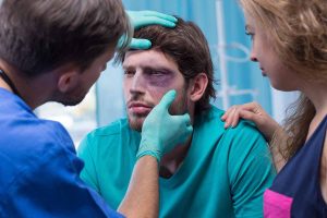 doctor assessing man hit in the eye with a ball