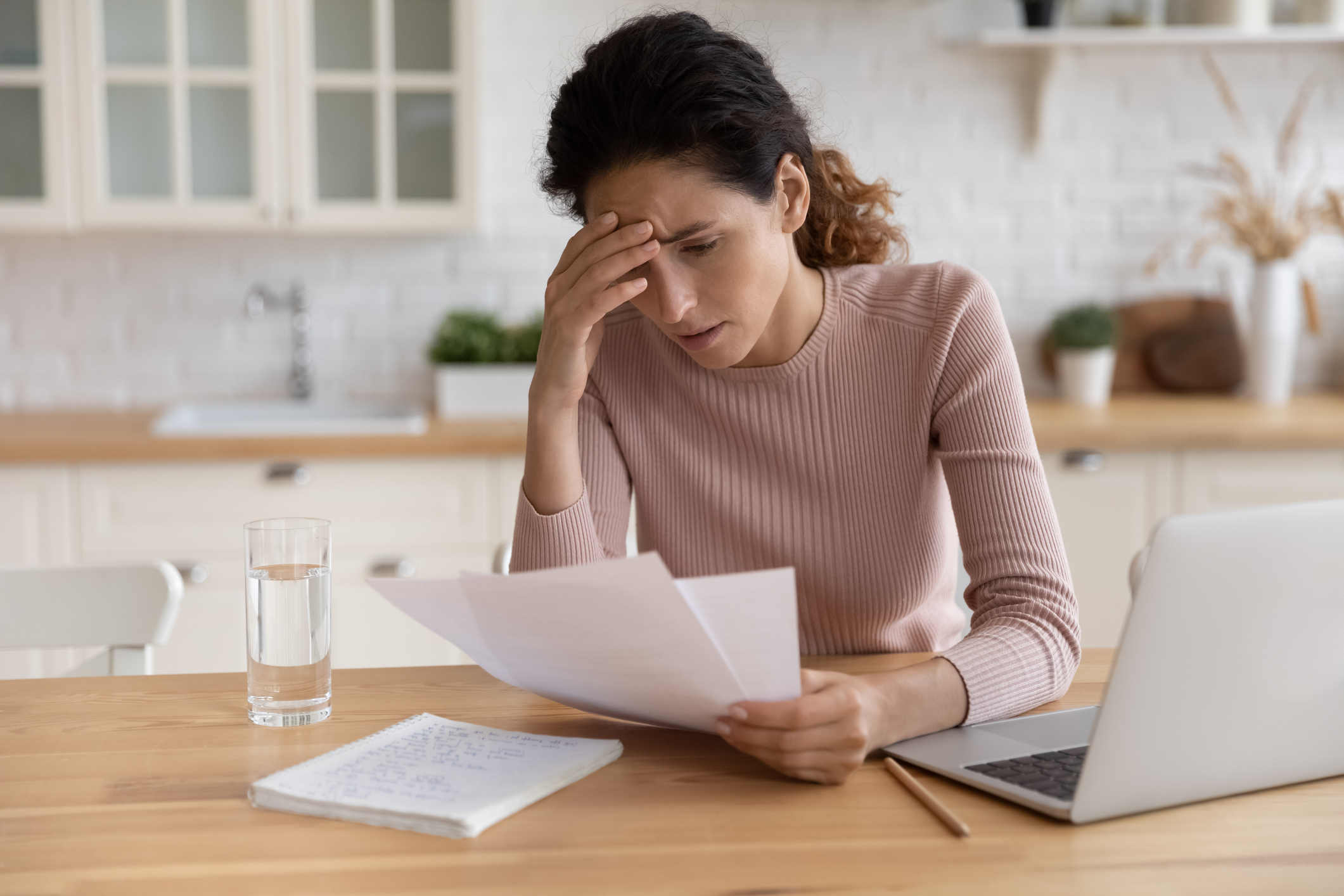 stressed millennial female think on bank notification about business bankruptcy