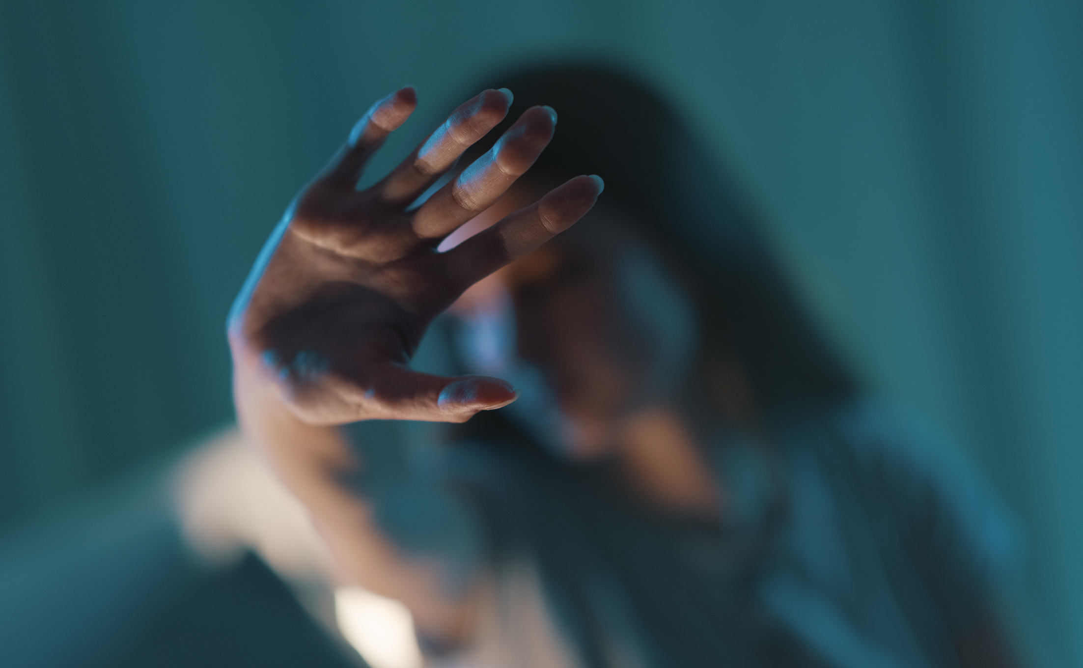 young woman doing a stop sign with her hand