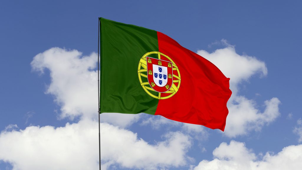 portugal flag is waving against in the sky.