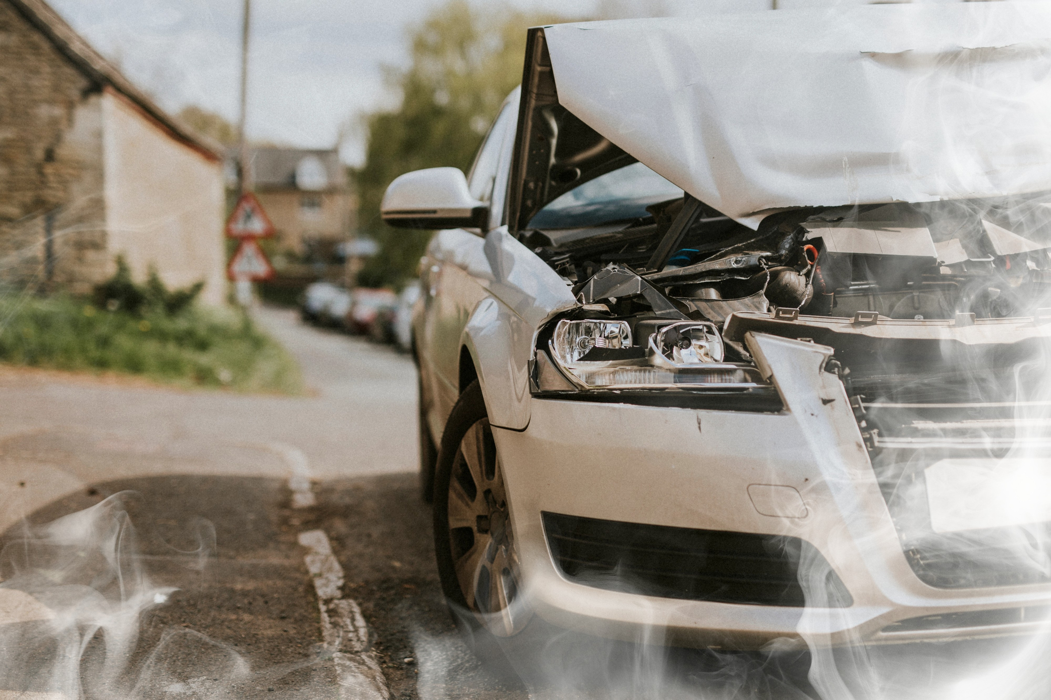 wrecked car parked on the street after a car crash