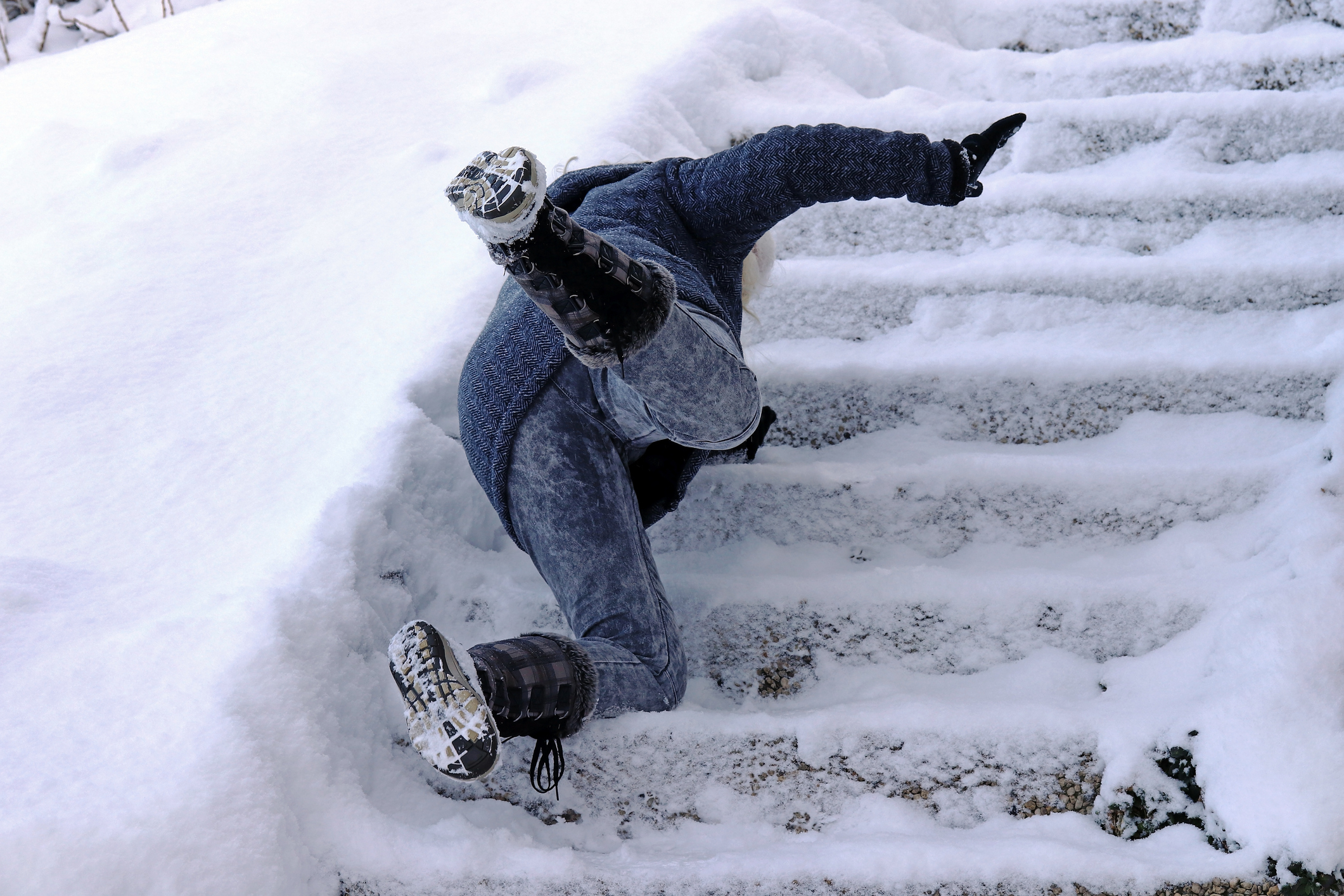 a woman slips and fell on a wintry staircase