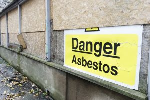 asbestos danger sign at building construction site refurbishment of old building