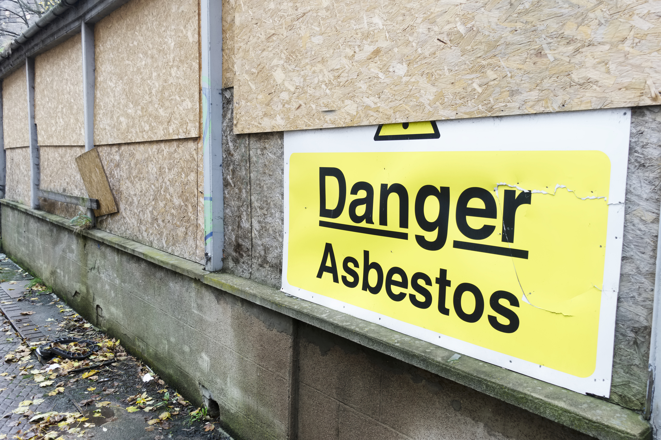 asbestos danger sign at building construction site refurbishment of old building