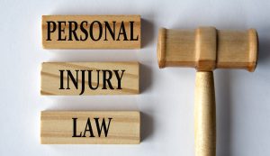 personal injury law words on wooden blocks on a white background with a judge's gavel.