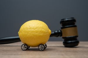 a lemon with wheels and a judge gavel.