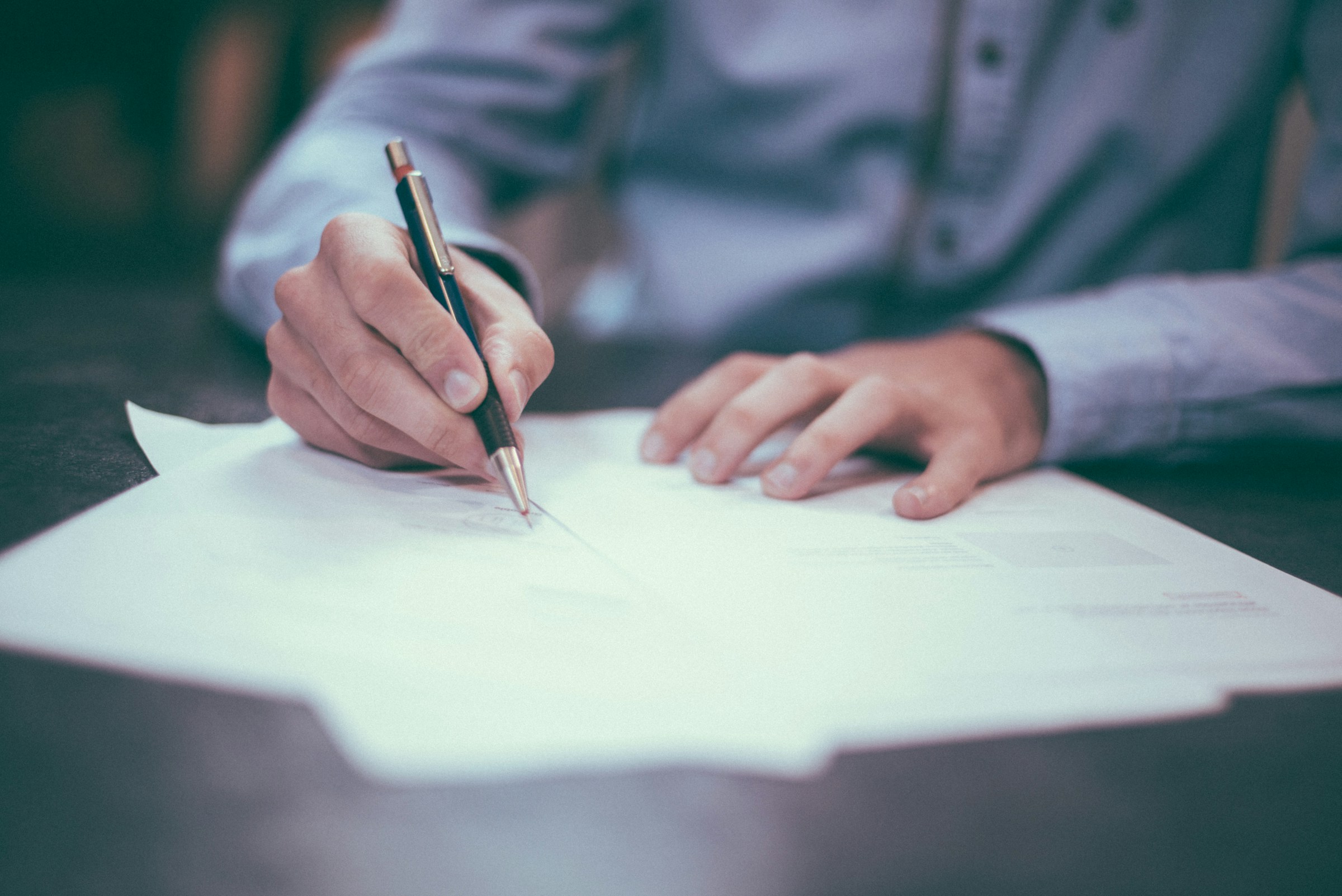 Man writing on a legal document