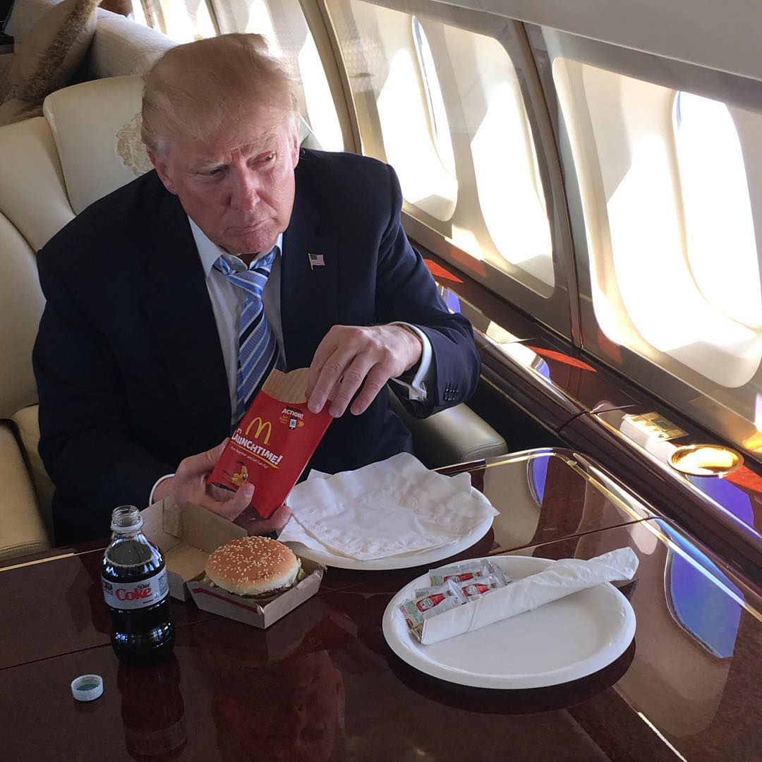 Trump eating McDonald's on a jet