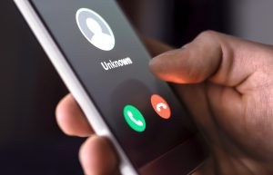 phone call from unknown number late at night. scam, fraud or phishing with smartphone concept. prank caller, scammer or stranger. man answering to incoming call.