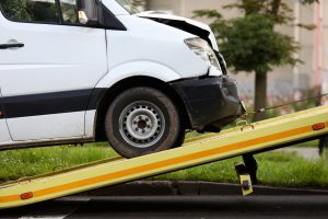 crashed car is immersed in tow truck closeup