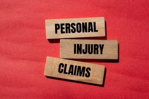 personal injury claims written on wooden blocks with red background