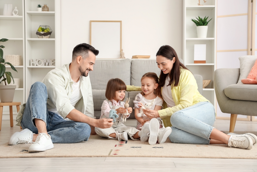 happy,family,playing,with,cute,toys,on,floor,at,home